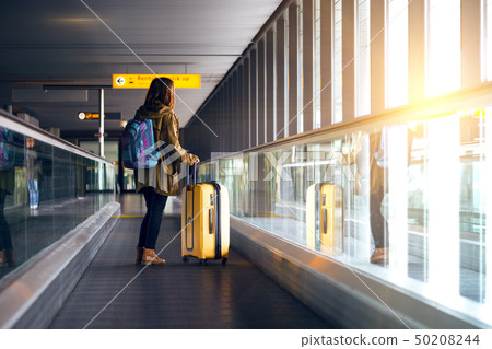 the girl is riding on the travolator 50208244