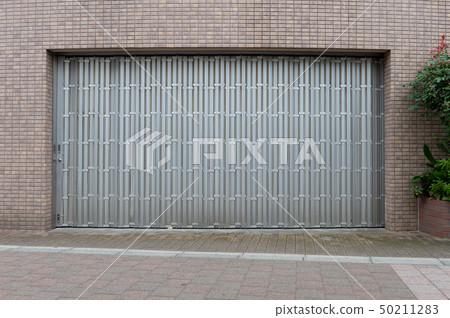 A closeup shot of automatic metal roller door used A closeup shot of automatic metal roller door used 50211283