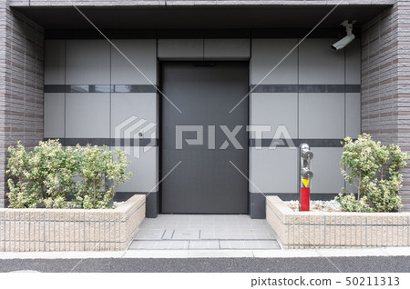 sidewalk by street wall & door sidewalk by street wall & door 50211313