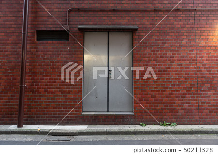 sidewalk by street wall & door sidewalk by street wall & door 50211328