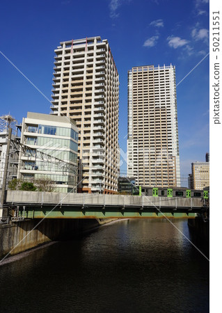 Yamanote Line and Gotanda Tower Mansions Crossing the Meguro River 50211551