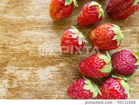 Strawberry on a wooden background. Strawberry on a wooden background. 50212888