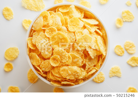 White cup with golden corn flakes, isolated on White cup with golden corn flakes, isolated on 50215246