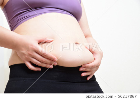 A woman holding a stomach luxury A woman holding a stomach luxury 50217867