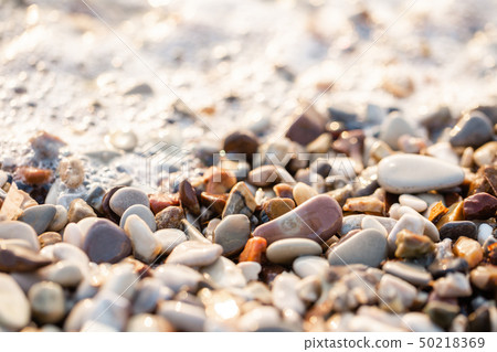 Close up beach stones on the seashore. Summer sunrise on coast, Corfu island, Greece. Beach Ionian Close up beach stones on the seashore. Summer sunrise on coast, Corfu island, Greece. Beach Ionian 50218369