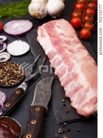 Fresh raw pork ribs on chopping board and vintage Fresh raw pork ribs on chopping board and vintage 50219777