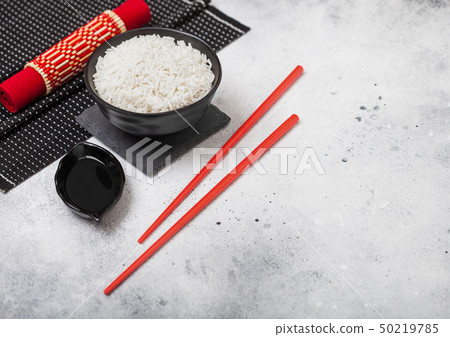 Black bowl with boiled organic basmati rice 50219785