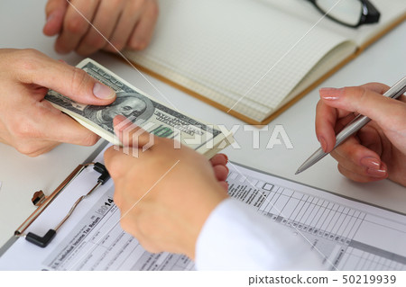 Male hand taking or giving bunch of hundred dollars bank notes Male hand taking or giving bunch of hundred dollars bank notes 50219939