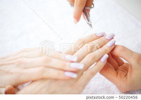 Woman hands in a nail salon receiving a manicure procedure. SPA manicure 50220456