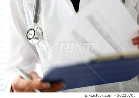 Female doctor hand hold silver pen 50220703