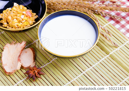 Milk in bowl with Cornflakes spices on wooden 50221815