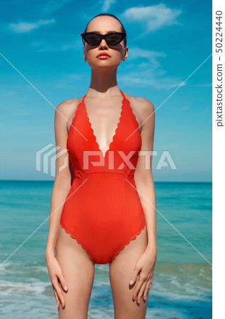 Sexy woman in beautiful sunglasses and red 50224440