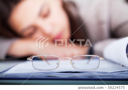 Tired and Overworked Business Woman Sleeping at Work Tired and Overworked Business Woman Sleeping at Work 50224575