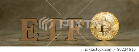 Bitcoin coin with ETF text on stone background Bitcoin coin with ETF text on stone background 50224610