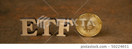 Bitcoin coin with ETF text on stone background Bitcoin coin with ETF text on stone background 50224651
