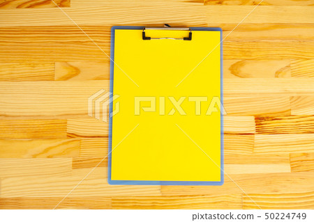 Blank Folder with Yellow Paper. Hand that Holding Folder and Handle on Wood Background. Copyspace 50224749