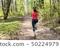 Fitness woman run in spring sunny forest 50224979