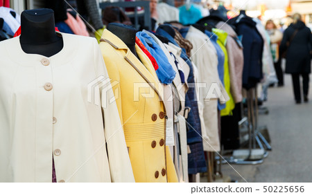 Row of mannequins with different coloured women's clothes on market Row of mannequins with different coloured women's clothes on market 50225656