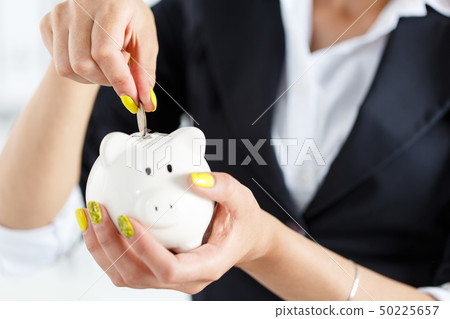 Piggy bank and woman 50225657