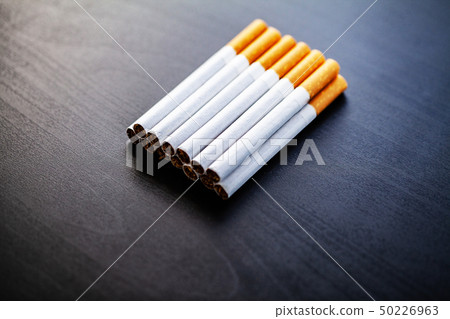 Stop smoking concept on background with broken cigarettes. Heap of cigarettes. No smoking Stop smoking concept on background with broken cigarettes. Heap of cigarettes. No smoking 50226963