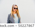 portrait of young woman in sunglasses 50227867