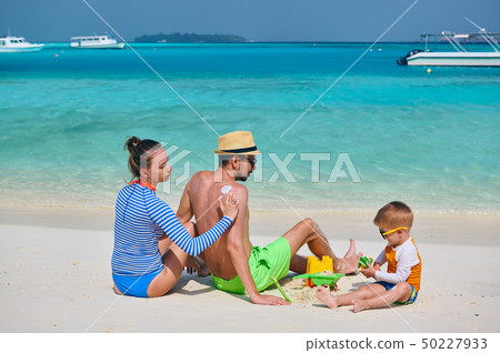 Family with three year old boy on beach 50227933