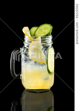 Cold fruit lemonade in mason jar isolated on black Cold fruit lemonade in mason jar isolated on black 50228302