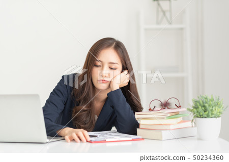 Bored young Asian woman working. 50234360