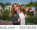Wind waving red haired girl in sunglasses 50238168