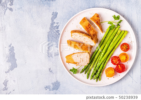 Roasted chicken breast with asparagus and Roasted chicken breast with asparagus and 50238939