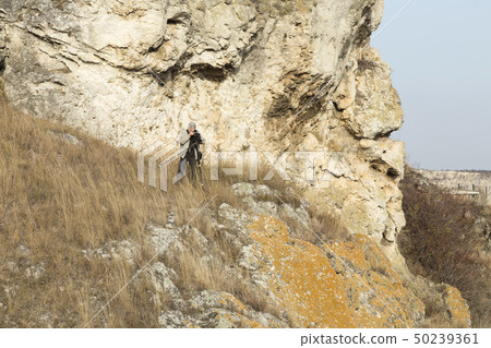 The photographer is doing a landscape shooting. The photographer is doing a landscape shooting. 50239361