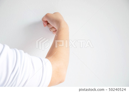 woman use her fist pounding the wall. woman use her fist pounding the wall. 50240524