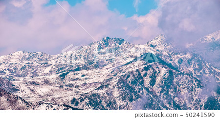Mountain top with scattered thick clouds. Mountain top with scattered thick clouds. 50241590