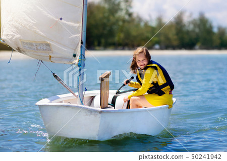 Child sailing. Kid learning to sail on sea yacht. Child sailing. Kid learning to sail on sea yacht. 50241942
