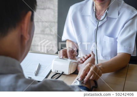 Doctor using a measuring blood pressure checking Doctor using a measuring blood pressure checking 50242406