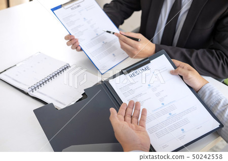 Employer or recruiter holding reading a resume 50242558