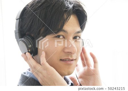Young man listening to music 50243215