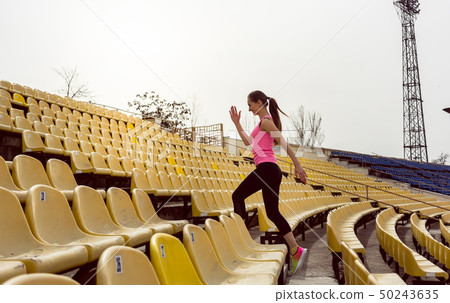 Woman walking on staircase 50243635