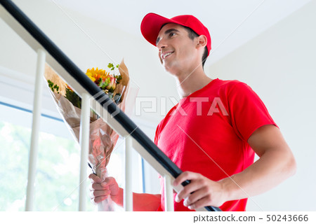 Delivery man holding flower bouquet gift 50243666