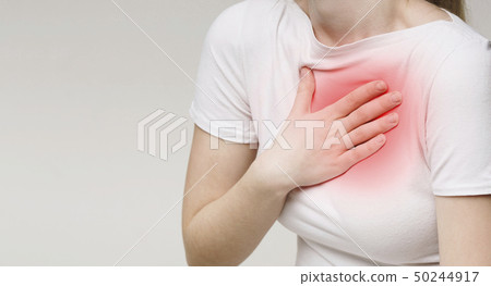 Woman suffering from acid reflux or heartburn 50244917