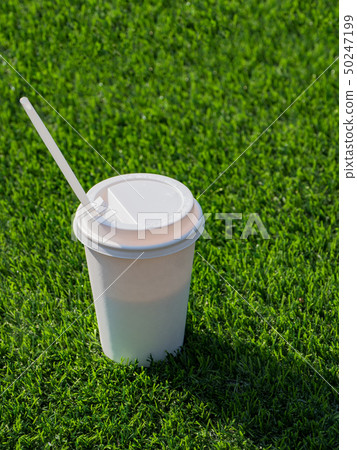 Drink in a paper cup with on the football field. 50247199