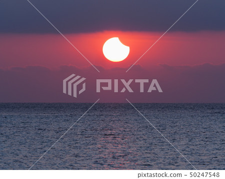 Partial Solar Eclipse Rising from the Sea / Partial Solar Eclipse over sea 50247548