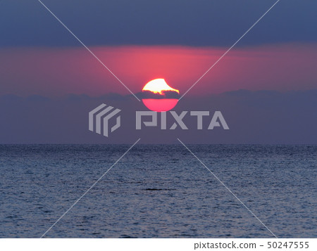 Partial Solar Eclipse Rising from the Sea / Partial Solar Eclipse over sea 50247555