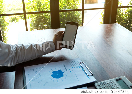 Businessman using smartphone to the situation. 50247854