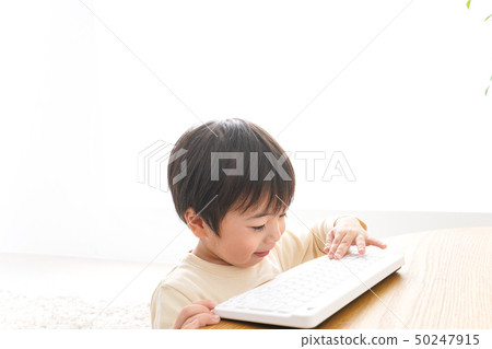 Kid playing with a laptop 50247915