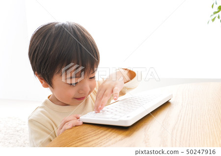 Kid playing with a laptop 50247916