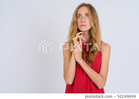Portrait of young beautiful blonde woman thinking and looking up 50249699