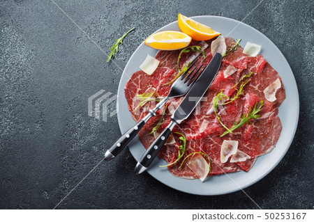 Marbled beef carpaccio with arugula. Marbled beef carpaccio with arugula. 50253167