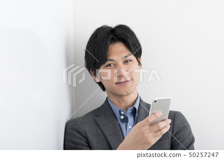 A male with a smartphone A male with a smartphone 50257247