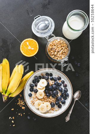 Healthy breakfast cereals with milk, blueberries, banana 50258644